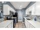 Efficient kitchen featuring white cabinetry, a tiled backsplash, modern appliances, and sleek countertops at 5995 N 78Th St # 1063, Scottsdale, AZ 85250