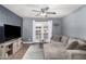 Cozy living room with a mounted TV, stylish console, comfortable sofa, and access to the outdoor patio at 5995 N 78Th St # 1063, Scottsdale, AZ 85250