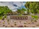 Exterior community sign reading 'Bella Vita' set among desert landscaping and mature trees at 5995 N 78Th St # 1063, Scottsdale, AZ 85250