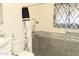 Bathroom featuring a modern toilet, shower with grab bar and decorative accents at 614 S 92Nd Pl, Mesa, AZ 85208