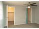 Bedroom with carpet, ceiling fan, with a closet and another doorway open for easy access at 614 S 92Nd Pl, Mesa, AZ 85208