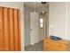 Bright bedroom featuring a folding door closet and wooden dresser at 614 S 92Nd Pl, Mesa, AZ 85208