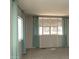 Bright bedroom featuring neutral walls, two windows with stylish curtains and comfortable carpet at 614 S 92Nd Pl, Mesa, AZ 85208