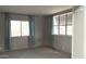 Carpeted bedroom featuring neutral walls, two windows with stylish curtains and great natural light at 614 S 92Nd Pl, Mesa, AZ 85208