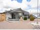 Single-story home with desert landscaping, a covered porch, and covered parking at 614 S 92Nd Pl, Mesa, AZ 85208