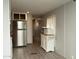 Bright kitchen area with stainless steel refrigerator and convenient microwave station at 614 S 92Nd Pl, Mesa, AZ 85208