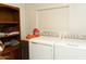 Laundry area with modern washer and dryer and storage shelving at 614 S 92Nd Pl, Mesa, AZ 85208