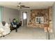Spacious living room with a ceiling fan, carpet, stone fireplace and multiple doorways at 614 S 92Nd Pl, Mesa, AZ 85208