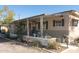 Inviting patio with table and chairs and desert landscaping surrounding the property at 643 S 93Rd St, Mesa, AZ 85208