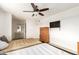 Bright bedroom with ceiling fan, two beds, and a dresser, and view of the ensuite bathroom at 6615 N 44Th Ave, Glendale, AZ 85301