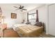 Bright bedroom with neutral walls, ceiling fan, two beds, and view to the outside through the window at 6615 N 44Th Ave, Glendale, AZ 85301