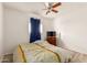 Bright bedroom with a wood-look floor, neutral walls, TV, and bed with decorative pillows at 6615 N 44Th Ave, Glendale, AZ 85301