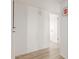 Hallway features laminate flooring, white walls, and access to other rooms at 6615 N 44Th Ave, Glendale, AZ 85301