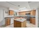 Bright kitchen with stainless steel appliances, wood cabinets, granite countertops, and center island at 6615 N 44Th Ave, Glendale, AZ 85301