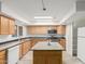 Bright kitchen with stainless steel appliances, wood cabinets and an eat-in kitchen island at 6615 N 44Th Ave, Glendale, AZ 85301