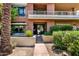 Exterior view of the Third Avenue Lofts building showcasing its red brick facade and manicured landscaping at 7301 E 3Rd Ave # 121, Scottsdale, AZ 85251