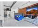 Stylish living room boasting exposed brick, a plush blue sofa, and a large screen at 7301 E 3Rd Ave # 121, Scottsdale, AZ 85251