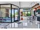 Bright living room featuring large windows, sleek floors, and modern decor leading into the kitchen at 7301 E 3Rd Ave # 121, Scottsdale, AZ 85251