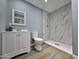 Well lit bathroom featuring stylish tile shower, modern vanity, and wood grain tile flooring at 770 S Pinal Dr, Apache Junction, AZ 85120