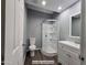 Well lit bathroom featuring a tile shower, modern vanity, and wood grain tile flooring at 770 S Pinal Dr, Apache Junction, AZ 85120