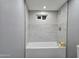 Modern bathtub with stylish tile surround and shower head, featuring a clean and bright space at 770 S Pinal Dr, Apache Junction, AZ 85120