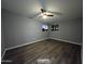 This bedroom features a ceiling fan and a large window overlooking the outdoors at 770 S Pinal Dr, Apache Junction, AZ 85120