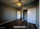 This bedroom features a ceiling fan, a large closet, and access to another room at 770 S Pinal Dr, Apache Junction, AZ 85120
