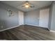 A spacious bedroom features wood floors, modern decor and a ceiling fan at 770 S Pinal Dr, Apache Junction, AZ 85120