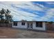 Inviting single-story home with a freshly painted exterior, enhancing its curb appeal and complemented by the beautiful sky at 770 S Pinal Dr, Apache Junction, AZ 85120