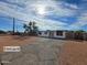 Charming single-story home showcasing a fresh exterior, complemented by a well-maintained front yard and blue skies at 770 S Pinal Dr, Apache Junction, AZ 85120