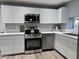 Close up of kitchen with stainless appliances, new white cabinets, and quartz countertops at 770 S Pinal Dr, Apache Junction, AZ 85120