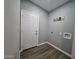 Neutral colored laundry room featuring wood-look vinyl floors and exterior door at 770 S Pinal Dr, Apache Junction, AZ 85120