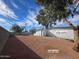 The home features a large side yard, fully fenced and graveled at 770 S Pinal Dr, Apache Junction, AZ 85120
