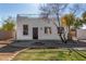 Charming two-story home showcasing a unique rooftop deck and landscaped front yard with mature desert plants at 7713 E Mawson Rd, Mesa, AZ 85207