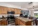 Kitchen featuring wood cabinets and granite countertops with stainless steel appliances at 904 W Juanita Ave, Mesa, AZ 85210