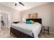 Serene main bedroom features a ceiling fan, a wooden bed frame, and neutral decor at 10136 E Southern Ave # 1114, Mesa, AZ 85209