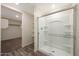 Modern bathroom with a glass shower enclosure, neutral color palette and walk in closet at 1057 W West Virginia Ave, Florence, AZ 85132