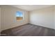 Cozy bedroom featuring plush carpeting, a window providing natural light, and neutral wall paint at 1057 W West Virginia Ave, Florence, AZ 85132