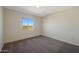Inviting bedroom featuring plush carpeting, a bright window with great light, and neutral wall paint at 1057 W West Virginia Ave, Florence, AZ 85132