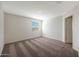Neutral bedroom with plush carpet, natural light from a window, and a spacious layout at 1057 W West Virginia Ave, Florence, AZ 85132