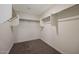 Spacious walk-in closet with ample shelving and rod space, perfect for organizing clothes and accessories at 1057 W West Virginia Ave, Florence, AZ 85132