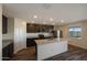 Modern kitchen with stainless steel appliances, granite countertops, and large central island at 1057 W West Virginia Ave, Florence, AZ 85132