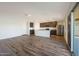 Open-concept kitchen and living area featuring modern appliances, island, and sliding door access at 1057 W West Virginia Ave, Florence, AZ 85132