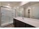 Modern bathroom featuring a glass-enclosed shower, large mirror and sleek vanity with dark cabinets at 1082 W 20Th St, Florence, AZ 85132