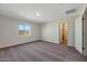 Bright, carpeted bedroom with a large window and walk-in closet at 1082 W 20Th St, Florence, AZ 85132