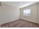 Cozy bedroom featuring neutral walls, carpet, and a bright window at 1082 W 20Th St, Florence, AZ 85132
