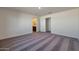 Spacious bedroom featuring neutral walls, carpet, and a bathroom ensuite, providing comfort at 1082 W 20Th St, Florence, AZ 85132