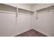 Walk-in closet with carpeted floors and white shelving for optimal storage at 1082 W 20Th St, Florence, AZ 85132