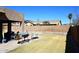 Spacious backyard featuring a built-in barbecue and lush green grass at 10916 E Cholla Rd, Mesa, AZ 85207