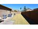 Large backyard with green grass and a tall block fence at 10916 E Cholla Rd, Mesa, AZ 85207